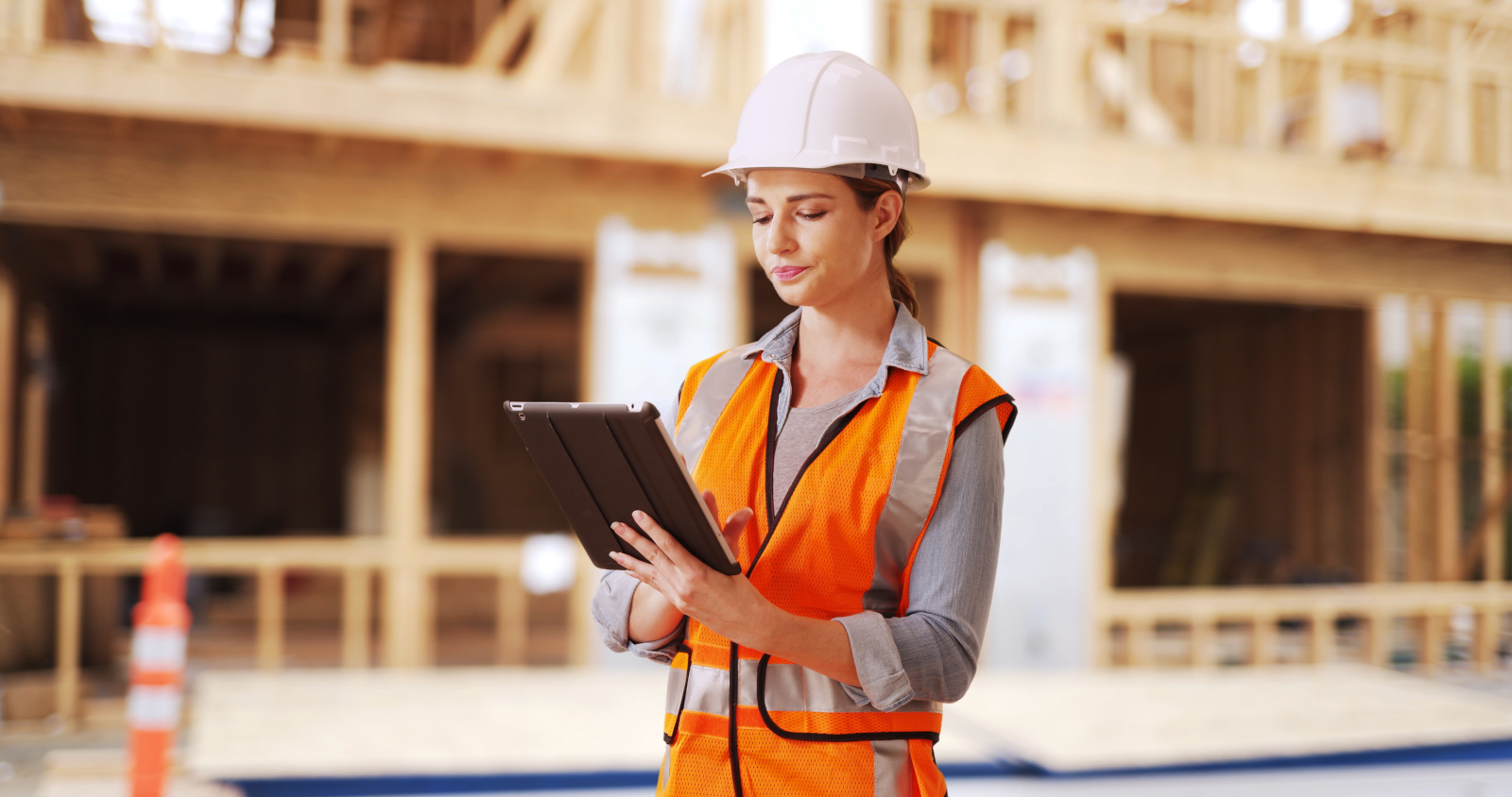 Female Quality Control inspector on construction site using the NestForms mobile form app